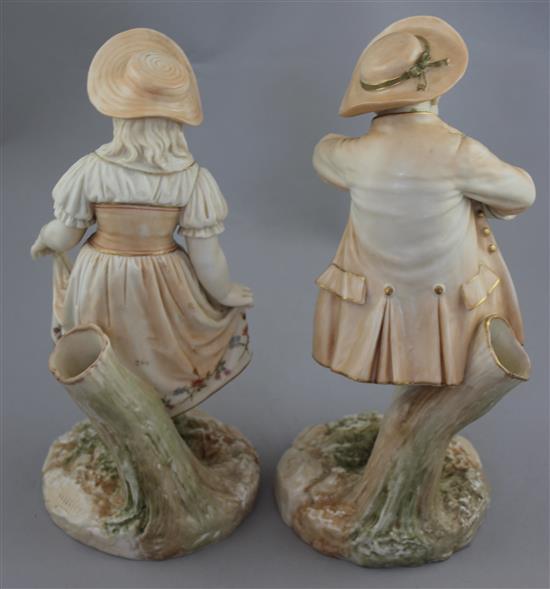 A pair of Royal Worcester blush ivory figures of Kate Greenway style children, modelled by James Hadley, 25.5cm and 24.5cm